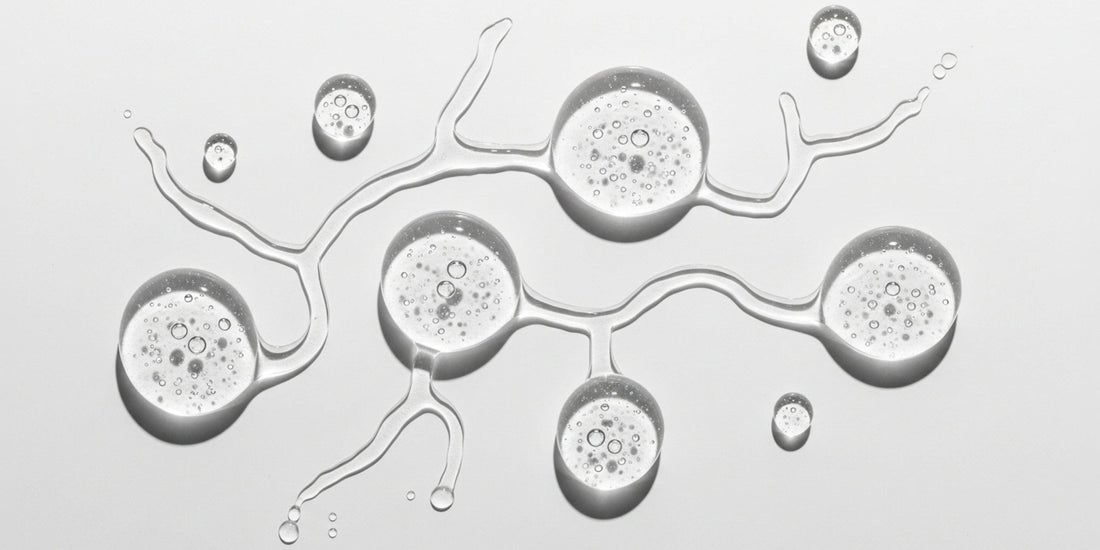 Close-up of water droplets on a surface with intricate patterns.